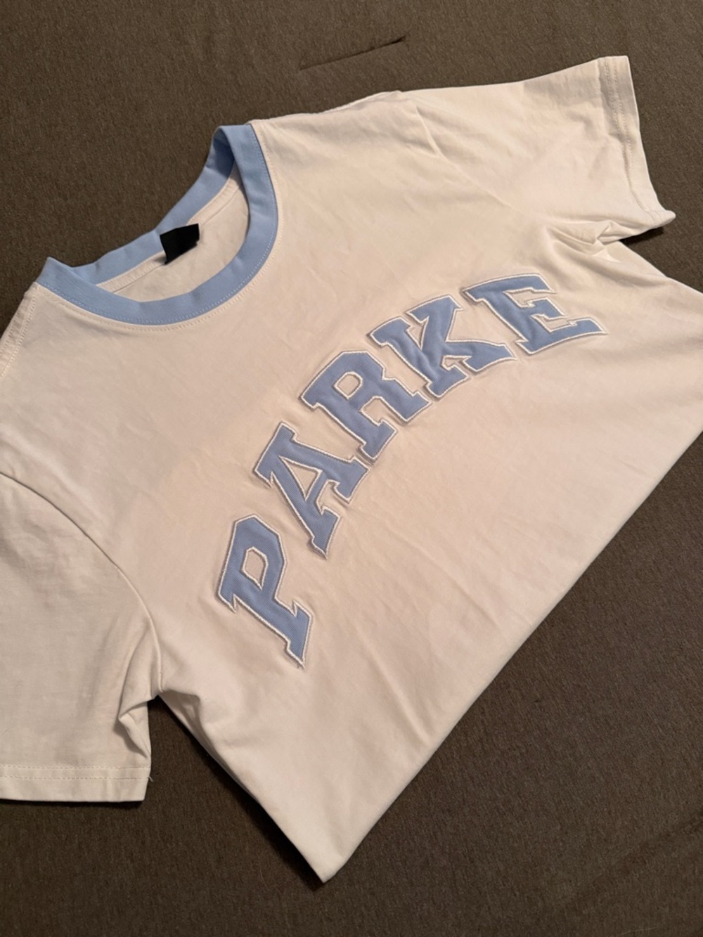 White Tee with Light Blue 'PARKE' Lettering
Size Small